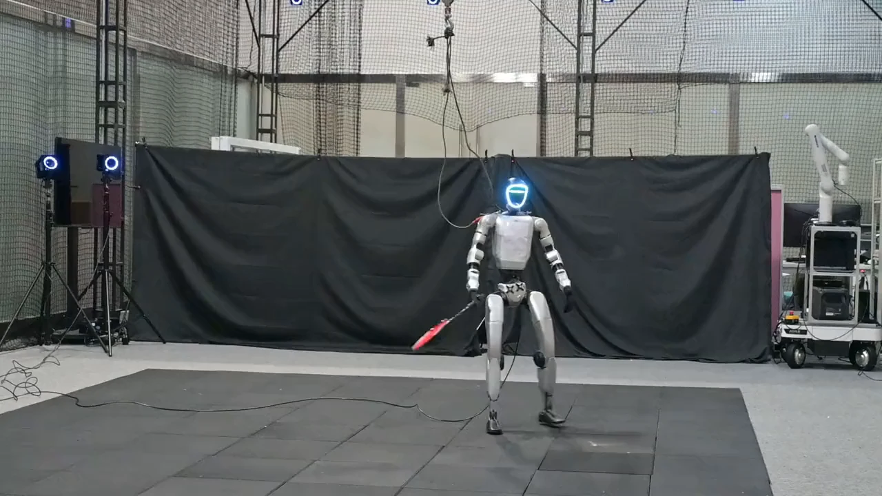 A still from the lab's footage: the humanoid robot steps across to return a shuttle with a backhand.